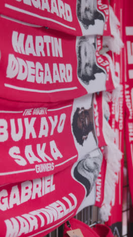 Vertical-Video-Of-Stall-Selling-Club-Merchandise-Outside-The-Emirates-Stadium-Home-Ground-Arsenal-Football-Club-London-With-Supporters-On-Match-Day